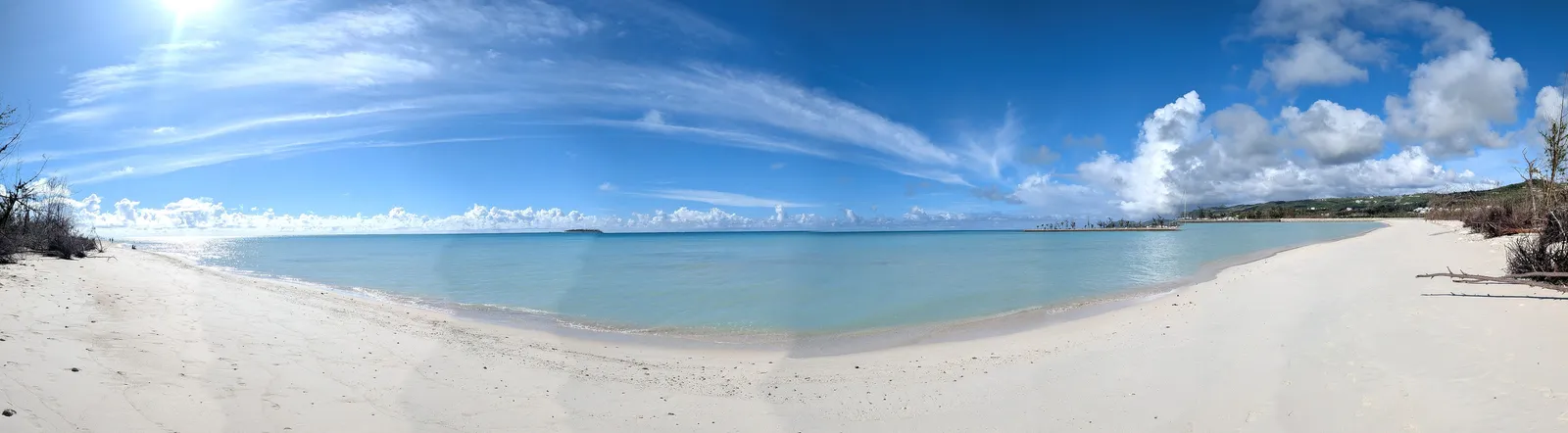 Panoramic view of Micro Beach's white sand curve toward Smiling Cove Marina, Garapan