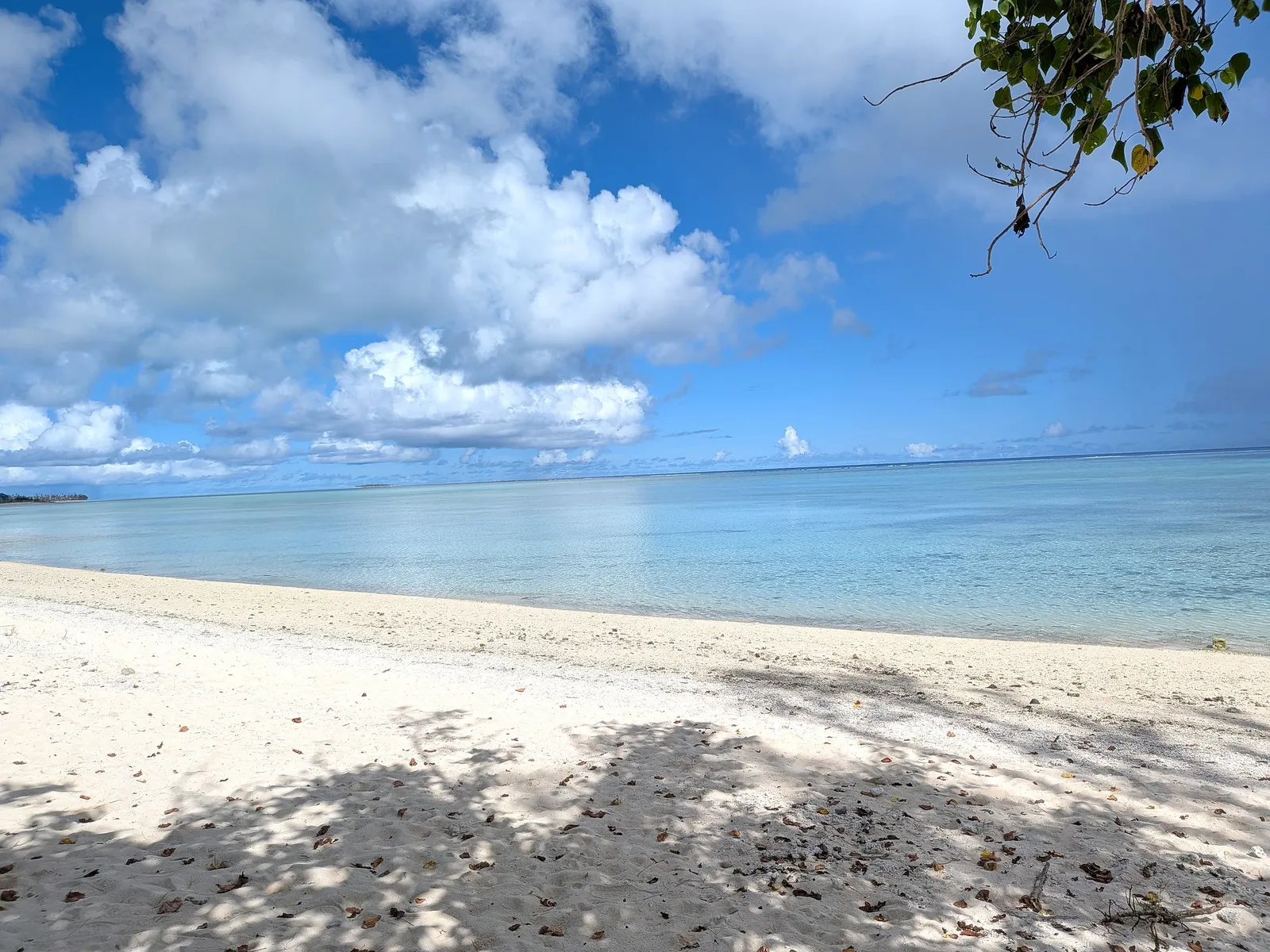 The beach at Paupau curving north toward a distant rocky point