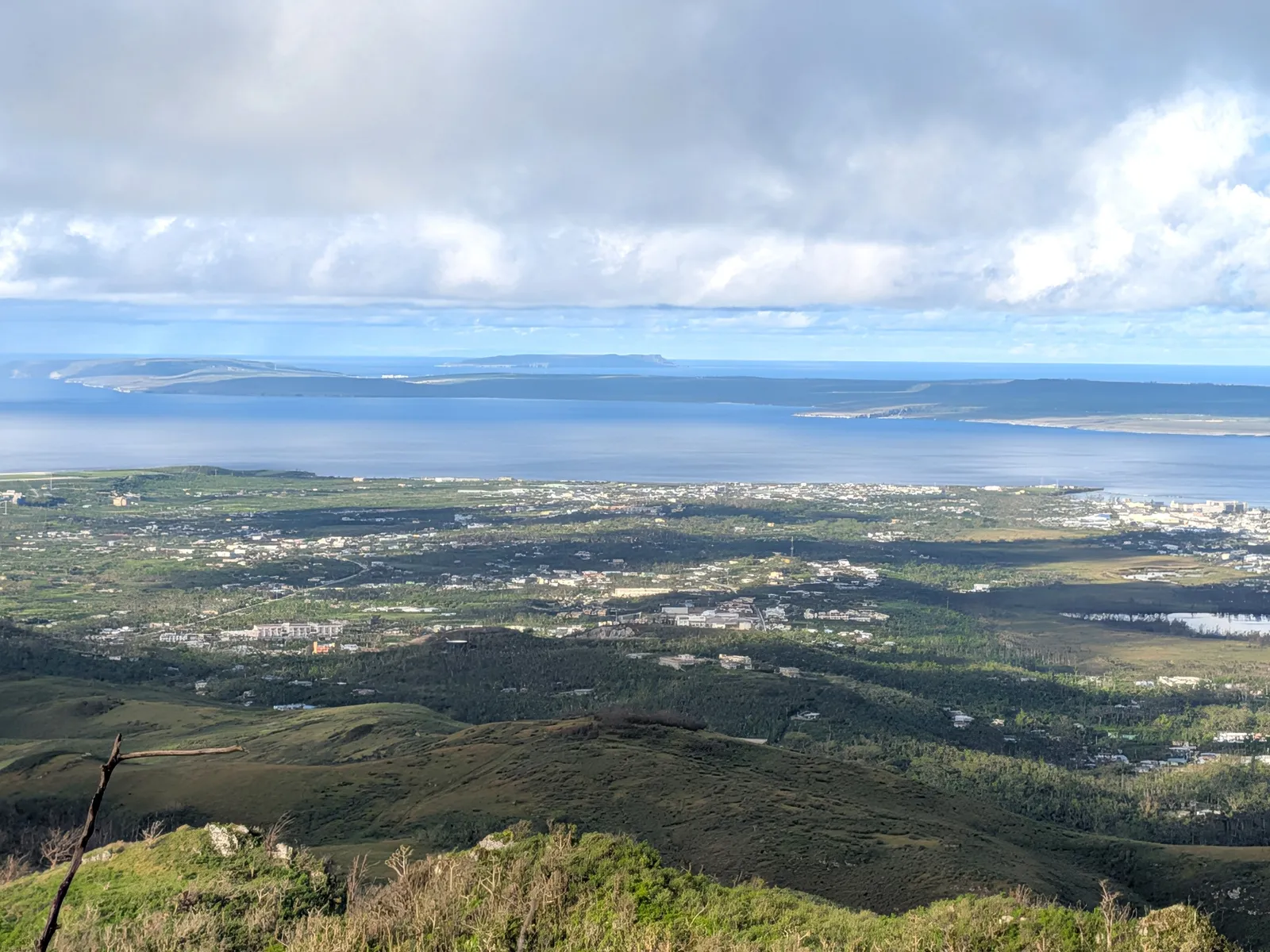 View east from Mount Tapochau toward Kagman and Magicienne Bay, with Managaha and the reef visible