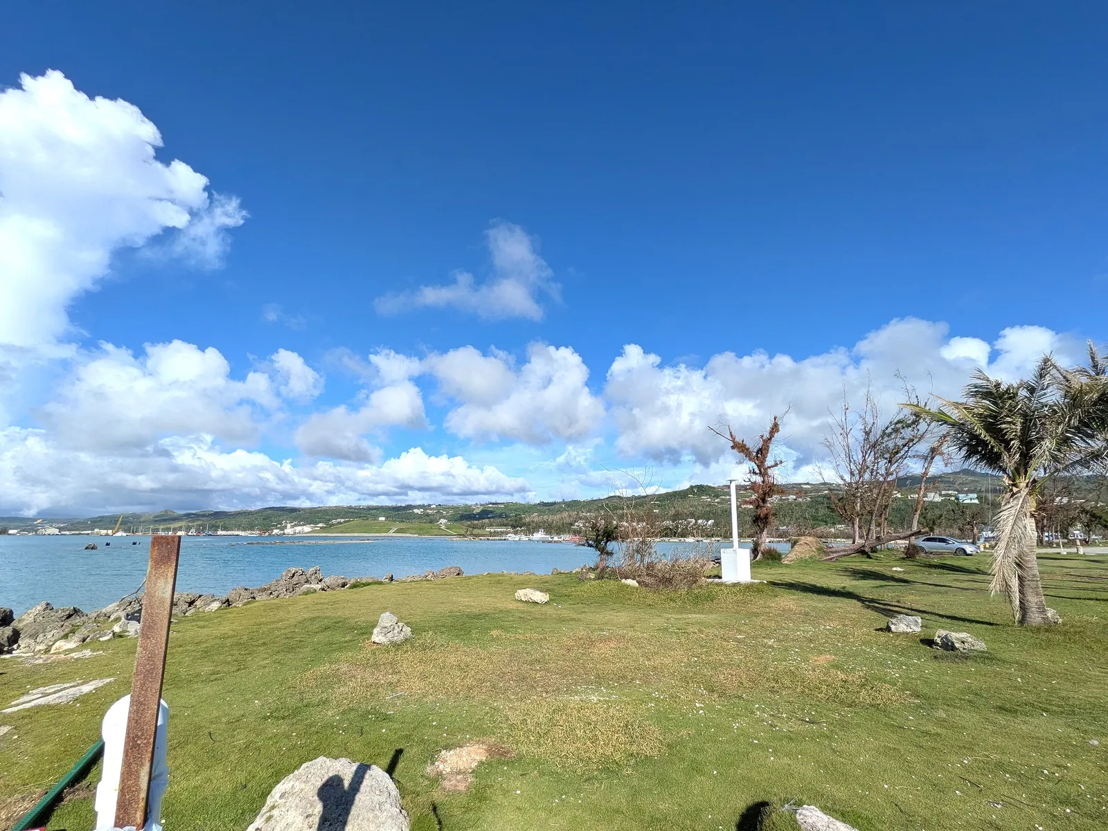 The grassy point at Smiling Cove Marina looking across the harbor toward Saipan's hillside