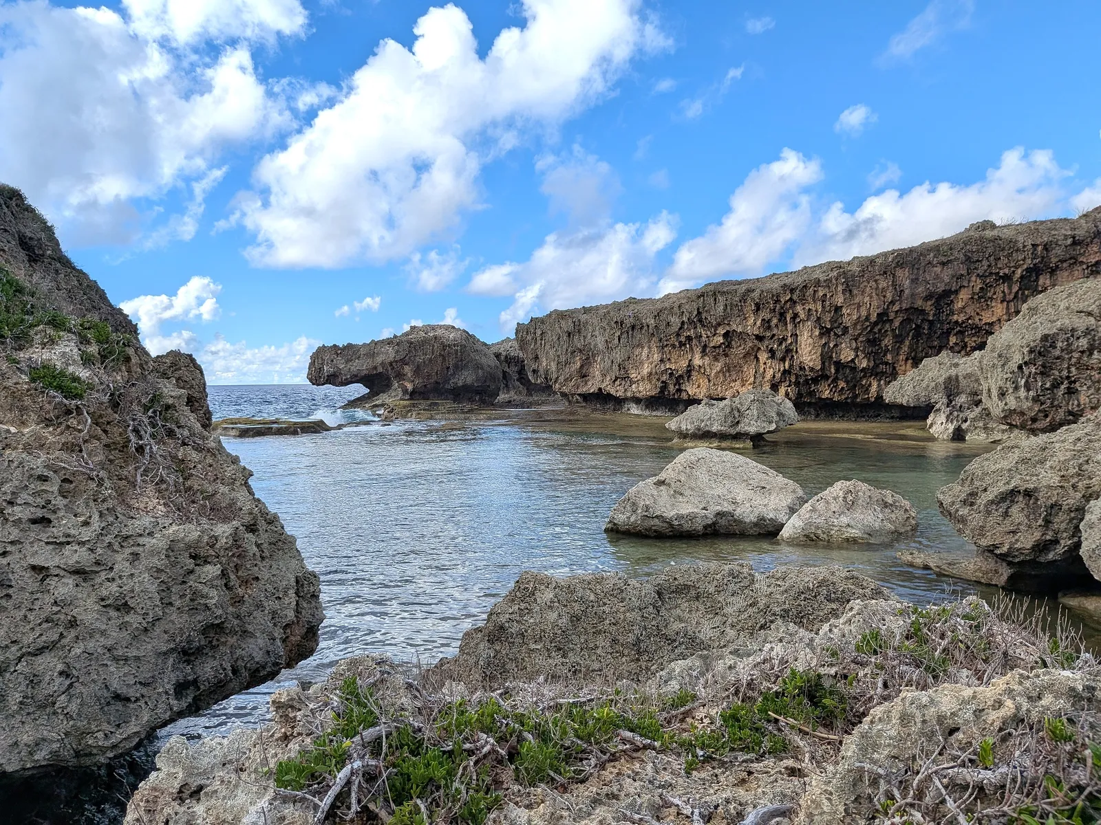 The sheltered inlet at Unai Fanhang seen from the surrounding limestone rocks