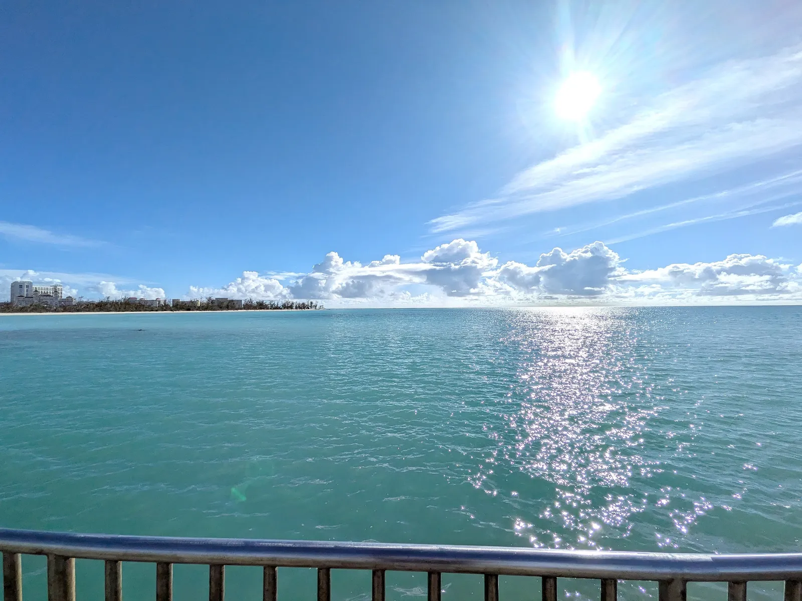 The Saipan lagoon from Smiling Cove's seawall, with Garapan's shoreline and hotels on the far side