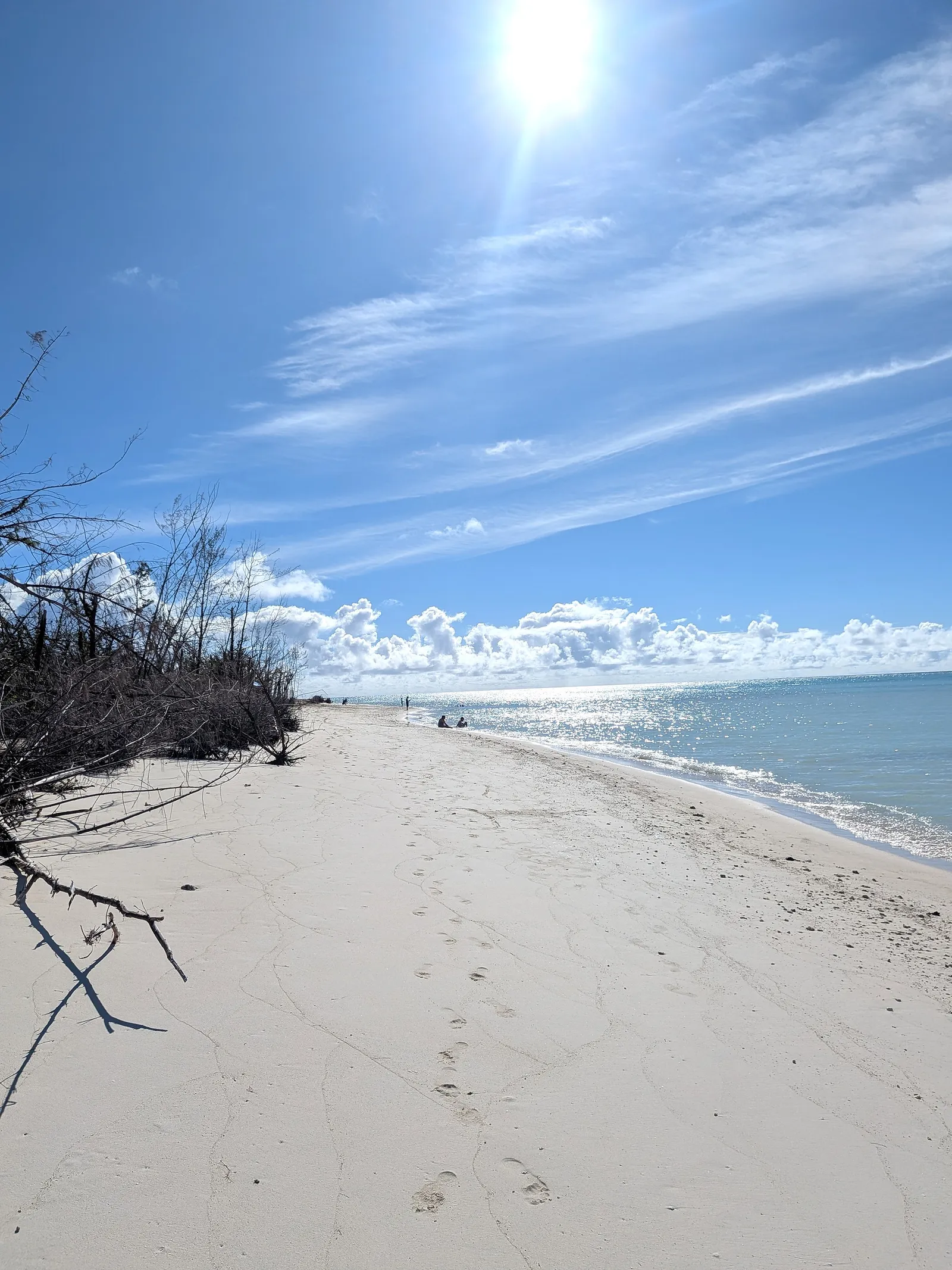 People wading and relaxing in the shallow water at Micro Beach