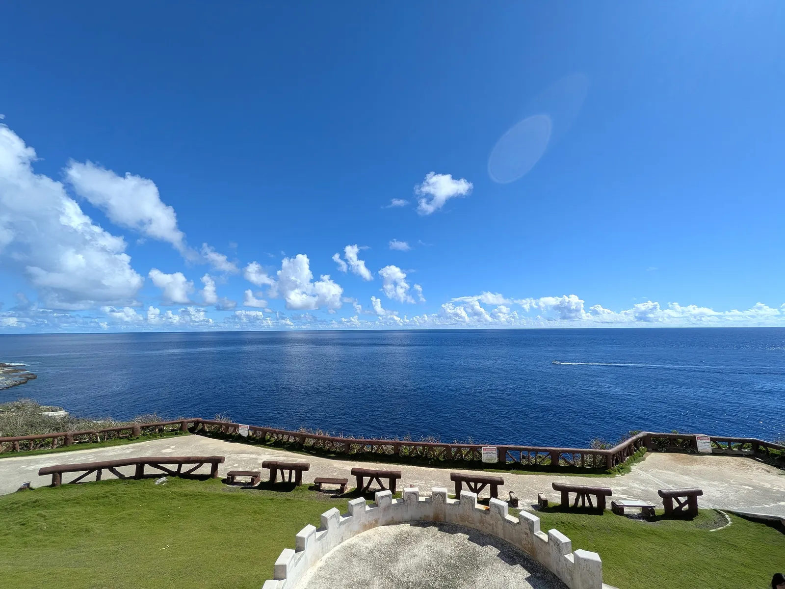 Benches and a semicircular viewing platform at the Banzai Cliff overlook, facing open ocean