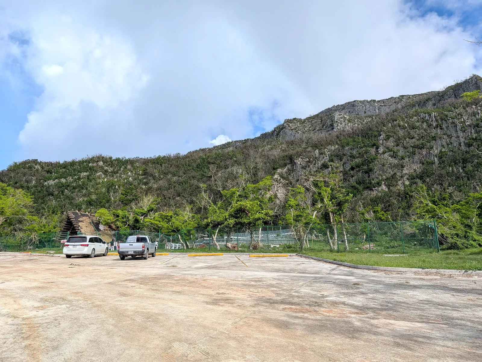 The paved parking area at Kalabera Cave, with the boardwalk and limestone ridge beyond