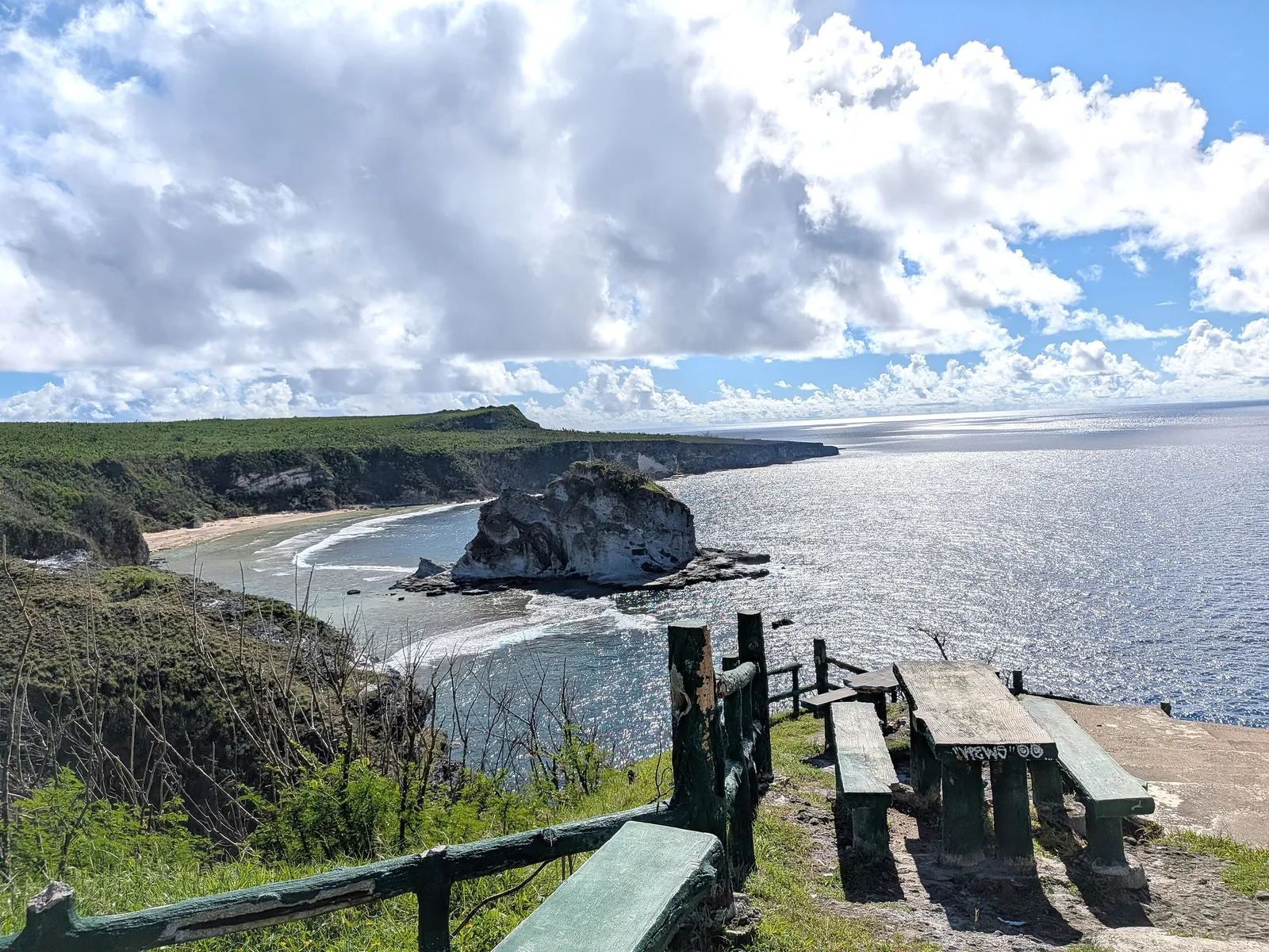 Concrete picnic tables and benches at the upper viewpoint of Bird Island Lookout, overlooking the bay
