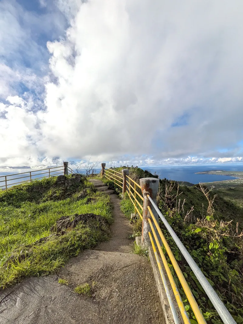 The narrow railed path along Mount Tapochau's summit ridge, with ocean visible on both sides