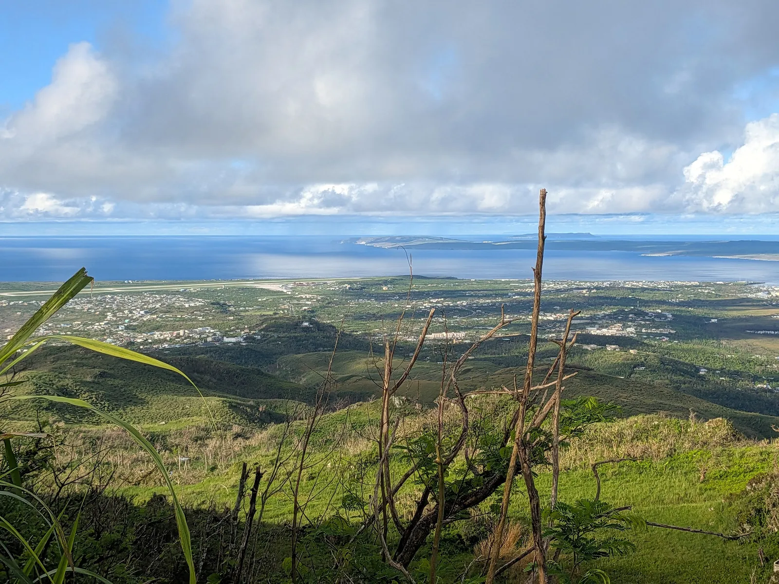 View south from Mount Tapochau with the silhouette of Tinian visible on the horizon